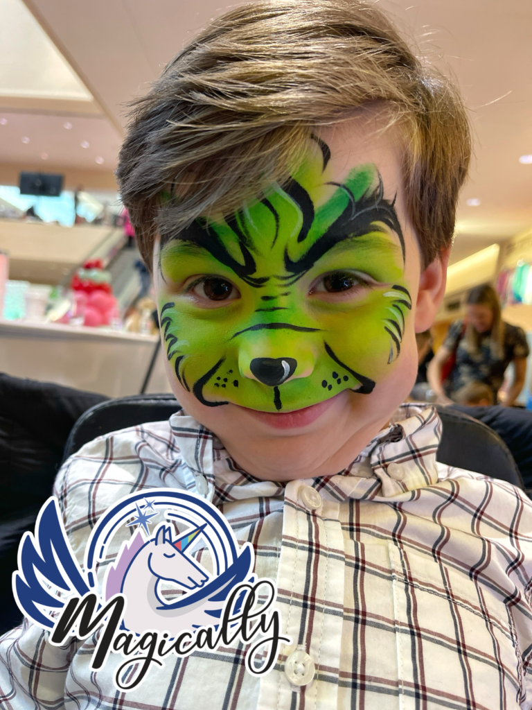 Festive Grinch face painting: a detailed and colorful holiday design perfect for Christmas events and celebrations.