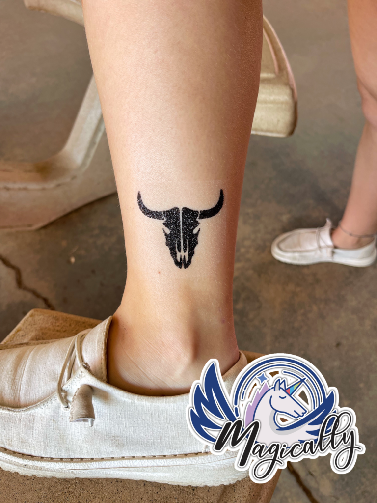 Glitter Tattoo of a longhorn design, featuring vibrant sparkles and bold, intricate details.