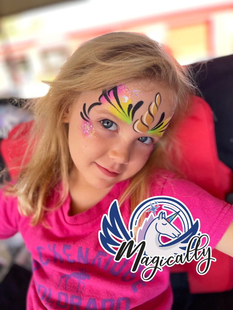 Adorable young girl with a colorful unicorn face painting, showcased in our gallery of creative designs for all occasions.