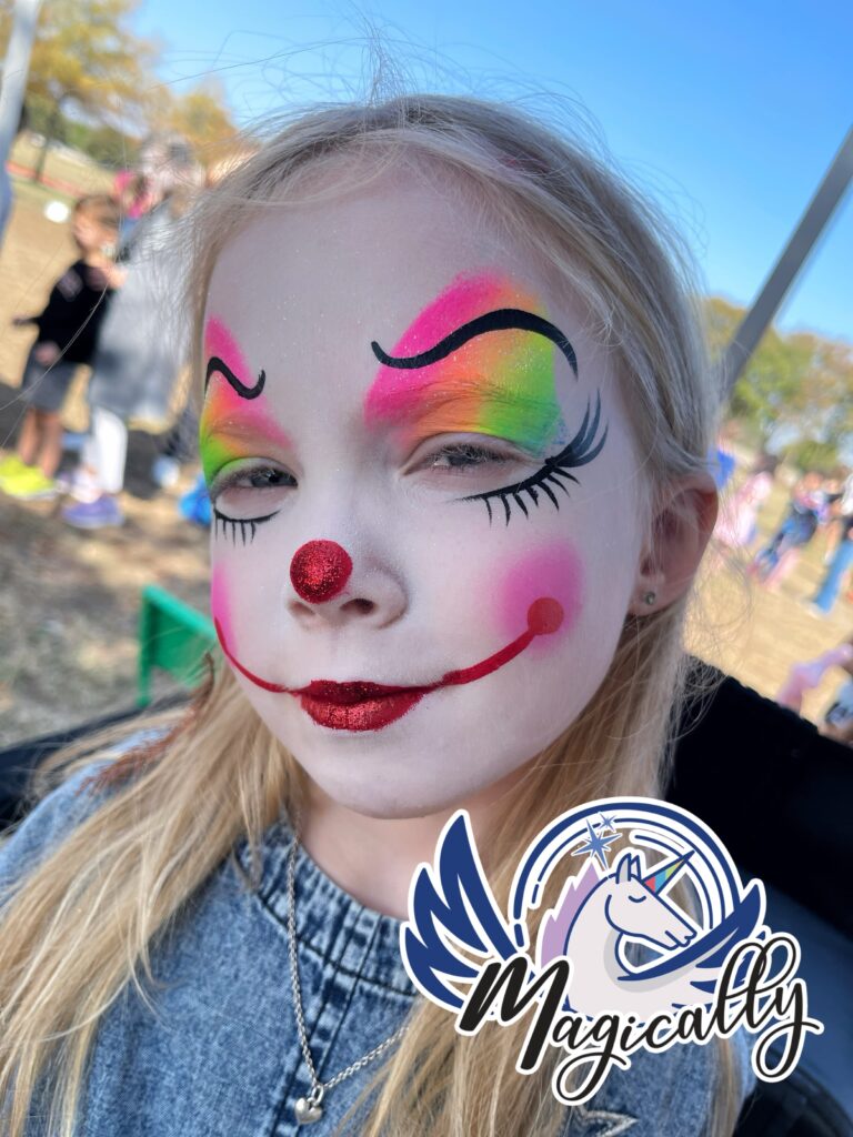 Young girl with colorful clown face painting, featuring a cheerful and playful design with bright colors and fun details