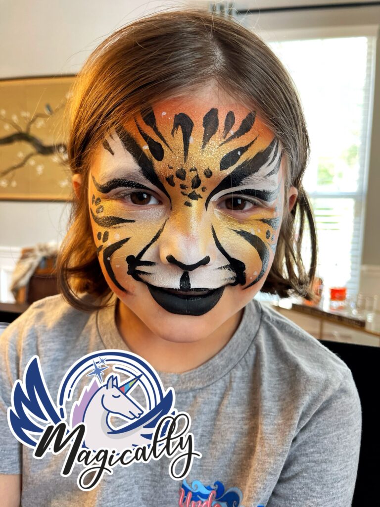 Young girl with a vibrant tiger face painting, featuring bold stripes and colorful details for a fun, wild look.